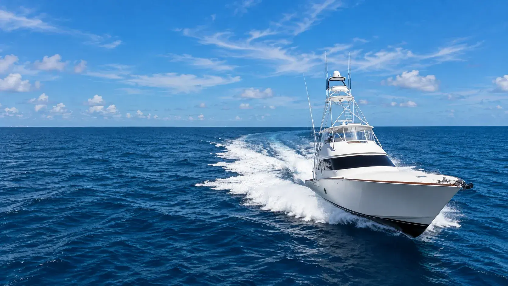 White sportfish convertible throwing a wake offshore